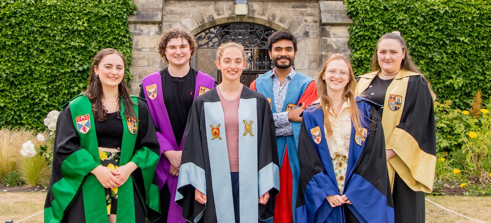 The Sabbatical Officers stand in St Salvator's Quad wearing their role gowns.