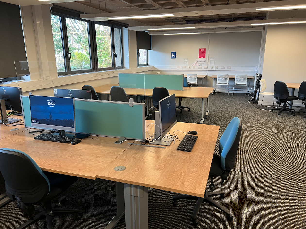 Chairs arranged around desks in the study room, with PCs on some of the desks