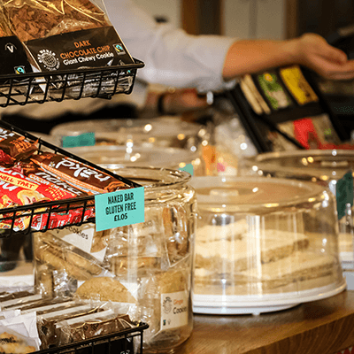 Cake and biscuits are sitting on the counter in Rector's Cafe.